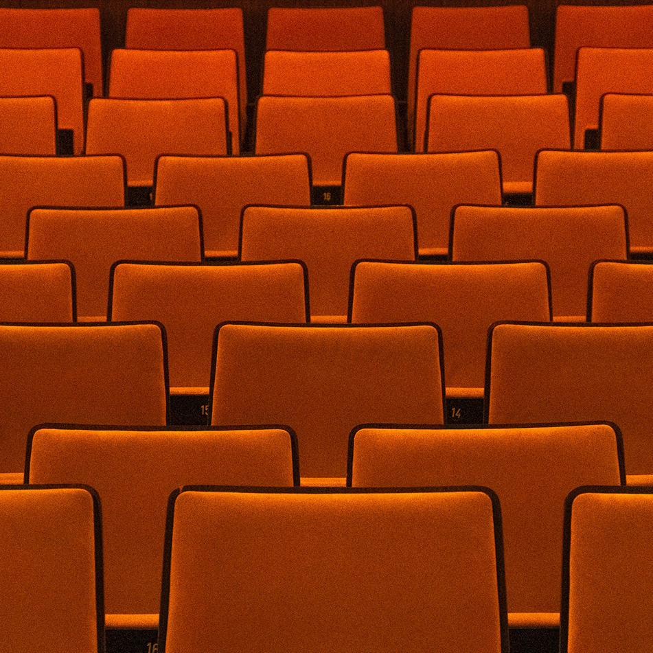 snapshot of some red chairs at a conference