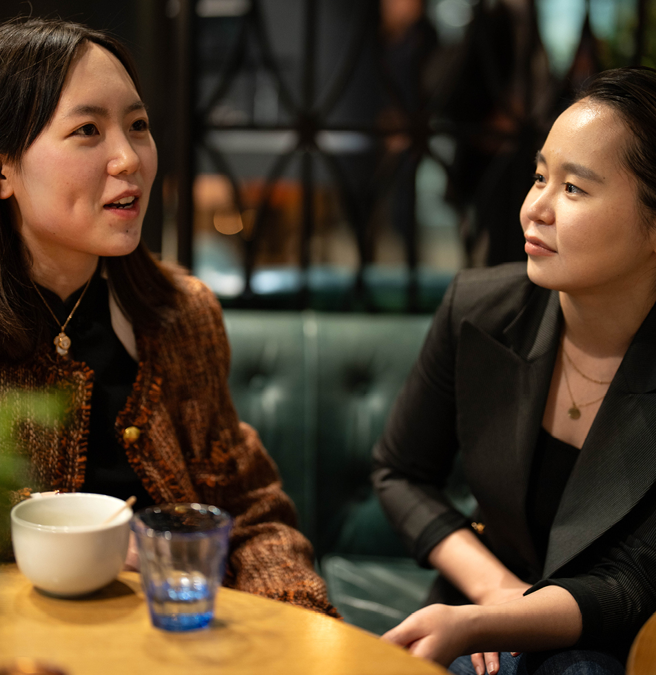 Two women talking at a networking event